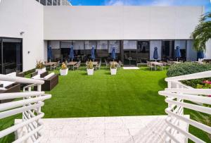 a lawn with chairs and tables in a building at Hilton Miami Downtown in Miami