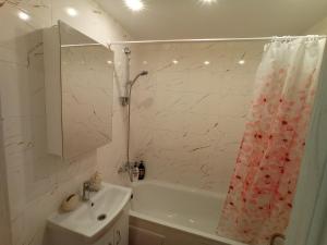 a bathroom with a sink and a shower curtain at New Energia apartment in center city in Narva