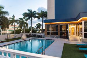 a swimming pool in front of a building at Hampton Inn & Suites Miami Airport South/Blue Lagoon in Miami