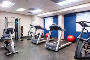 a gym with several treadmills and exercise bikes at Hampton Inn & Suites Miami Airport South/Blue Lagoon in Miami
