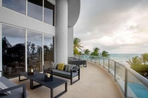a balcony of a hotel with a view of the ocean at DoubleTree by Hilton Ocean Point Resort - North Miami Beach in Miami Beach