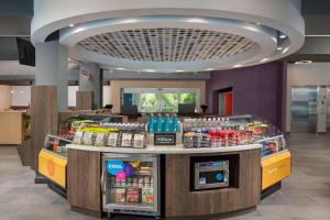 a food counter in a store with food and drinks at Tru By Hilton Miami West Brickell in Miami