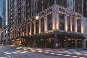 a large building on a city street at night at Hotel Phillips Kansas City, Curio Collection By Hilton in Kansas City