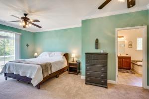 a bedroom with a bed and a ceiling fan at Semora Vacation Rental with Dock on Hyco Lake! in Semora