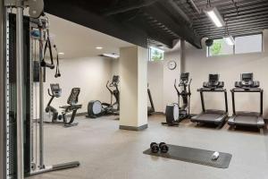 a gym with several treadmills and elliptical machines at Hampton Inn Suites Kansas City Downtown Crossroads in Kansas City