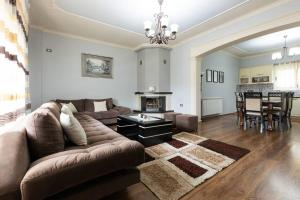 a living room with a couch and a table at Lake Retreat Villa in Shkodër