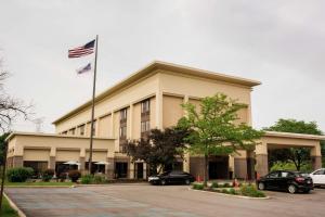 a building with an american flag on top of it at Hampton Inn Milwaukee Northwest in Milwaukee