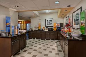 a large room with a counter in a store at Hampton Inn Milwaukee Northwest in Milwaukee