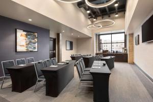 uma sala de jantar com mesas e cadeiras pretas em Homewood Suites By Hilton Milwaukee Downtown em Milwaukee