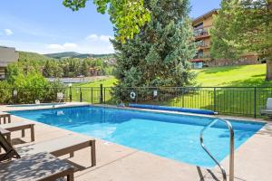 a swimming pool with a fence around it at Lichenhearth 30 in Snowmass Village