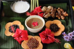 a tray of food with flowers and other foods on it at Bagus Jati Health & Wellbeing Retreat in Tegalalang