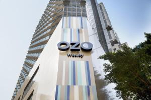 a large building with a clock on the side of it at OZO Wesley Hong Kong in Hong Kong