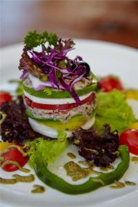 a white plate with a sandwich with vegetables on it at Bagus Jati Health & Wellbeing Retreat in Tegalalang