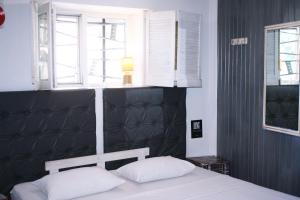 Postel nebo postele na pokoji v ubytování Mamba Hotel