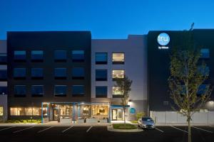 a building with a car parked in a parking lot at Tru By Hilton Manassas, Va in Manassas