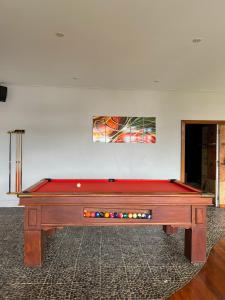 a pool table in the middle of a room at Iro Luxury Retreat in Rarotonga