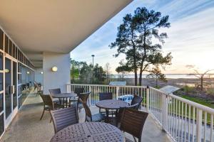 a balcony with tables and chairs and a view of the water at Hampton Inn Mobile/East Bay in Daphne