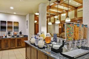 a restaurant with a counter with vases on it at Homewood Suites Mobile East Bay/Daphne in Daphne