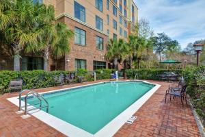 a swimming pool with chairs and a building at Homewood Suites Mobile East Bay/Daphne in Daphne