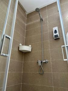 a shower in a bathroom with a shower at Ifrane apartment with swimming pool in Ifrane