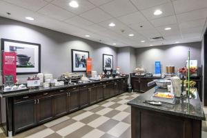 a restaurant with a buffet line with food at Hampton Inn Foley in Foley