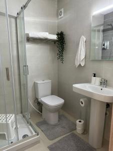 a bathroom with a toilet and a sink and a shower at Ifrane apartment with swimming pool in Ifrane +19 photos