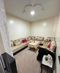 a living room with a couch and a table at Sidi Youssef Agadir in Agadir