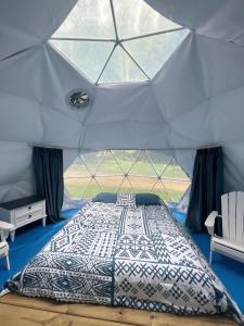 a bedroom with a bed in a tent at Harmony Tree Resorts inc in Nashville