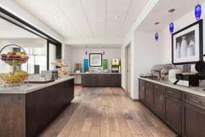 a large kitchen with wooden cabinets and a counter top at Hampton Inn by Hilton Turlock in Turlock
