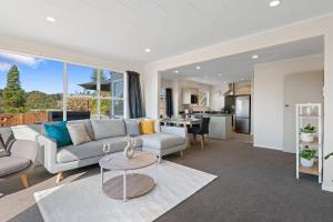 a living room with a couch and a table at Top Spot Rotorua in Rotorua