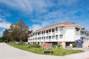 a white building with a sign in front of it at Hampton Inn Monterey in Monterey