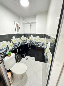 a bathroom with a toilet and a counter with sinks at Sidi Youssef Agadir in Agadir