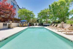 a swimming pool with lounge chairs and a building at Hampton Inn & Suites Mooresville in Mooresville