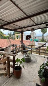 a patio with a hammock and a fence at Vive en un rancho in Puebla