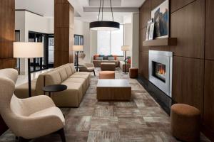 a living room with a couch and a fireplace at Hilton Garden Inn Minneapolis Downtown in Minneapolis