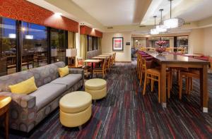 a restaurant with a couch and a table and chairs at Hampton Inn Minneapolis/Eagan in Eagan