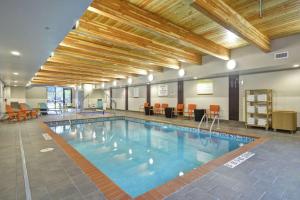 a large swimming pool in a large room with at Home2 Suites By Hilton Minneapolis-Eden Prairie in Minnetonka