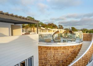 a balcony with two chairs on top of a house at Cardiff By The Sea Lodge in Encinitas