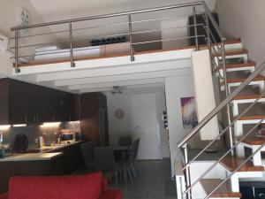 a living room and kitchen with a loft bed at Calma Luxury House in Marmari