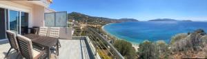 a balcony of a house with a view of the ocean at Calma Luxury House in Marmari