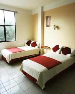 a hotel room with two beds and a window at Hotel Plaza Center in Santa Cruz de la Sierra