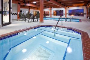 a large swimming pool in a hotel room with a pool at Hampton Inn Minneapolis Northwest Maple Grove in Maple Grove