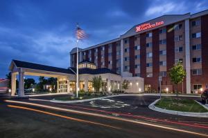 a hotel with an american flag on top of it at Hilton Garden Inn Minneapolis Airport Mall of America in Bloomington