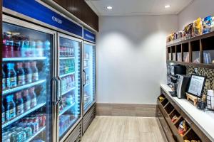 a store aisle with a refrigerator with drinks at Hilton Garden Inn Minneapolis Airport Mall of America in Bloomington