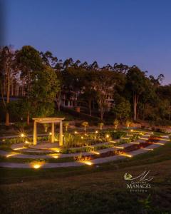 a garden lit up at night with lights at Quinta dos Manacás Pousada - Pedra Azul - Rota dos Lagos in Pedra Azul