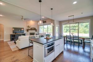 a kitchen and living room with a table and chairs at Fayetteville Vacation Rental with Deck and Shared Pool in Fayetteville