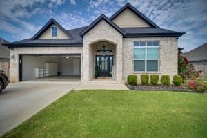 a house with a driveway and grass at Fayetteville Vacation Rental with Deck and Shared Pool in Fayetteville