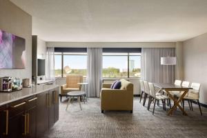 a hotel room with a dining area and a living room at DoubleTree by Hilton St. Paul, MN in Saint Paul
