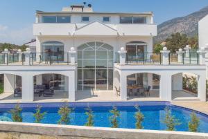 a house with a pool in front of it at Orka World Villa 2 in Oludeniz