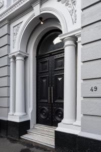 a black door with an archway on a building at Boujee on Bond in Dunedin